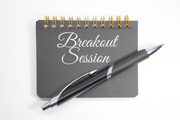 notebook and pen with the word breakout session