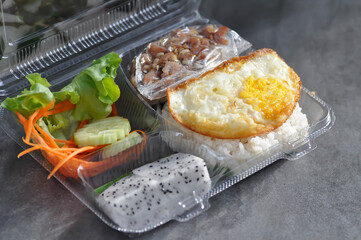 fried pork or stir fried pork with fruit and rice in the box