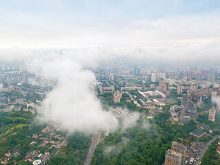 High flight above the clouds in Kiev. Spring morning. Aerial high view.