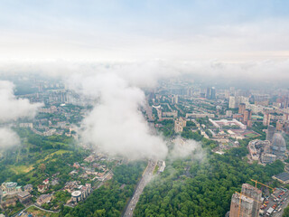 Fototapeta premium High flight above the clouds in Kiev. Spring morning. Aerial high view.