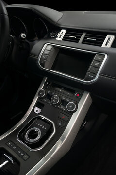 Modern luxury car control panel. Interior detail. Vertical photo.