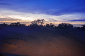 night extreme travel in Sahara huge sand dunes in sunset