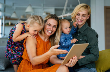 Fototapeta na wymiar Young modern cheerful family talking through video-chat