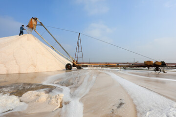 Raw salt production equipment in operation in a saltworks, North China