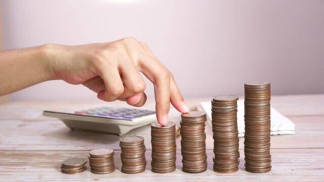 Money growth Saving money. coins to shown concept of growing business. Fingers walking up on coins stack or money stack.