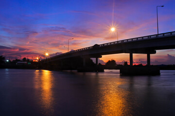 Fototapeta na wymiar Bridge over the river in the evening with beautiful sky