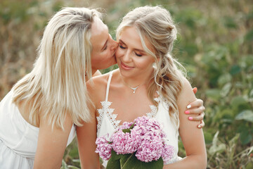 Fototapeta premium Mother with beautiful daughter in a autumn field