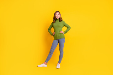 Fototapeta na wymiar Full length body size photo smiling girl in casual clothes jeans sneakers isolated vivid yellow color background