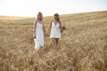 Mother with beautiful daughter in a autumn field