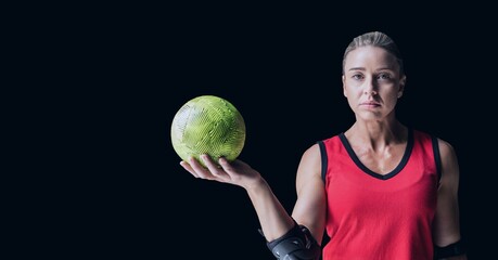 Composition of caucasian female handball player holding ball with copy space on black background
