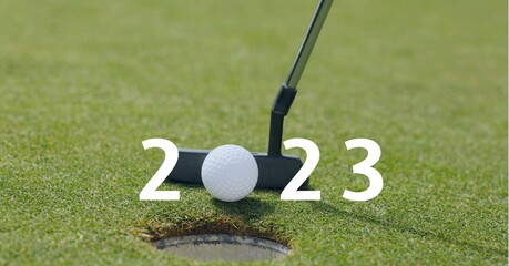 Composition of 2023 number with golf ball and golf club on golf course