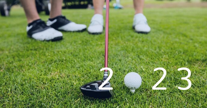 Composition of 2023 number with golf ball and golf club on golf course