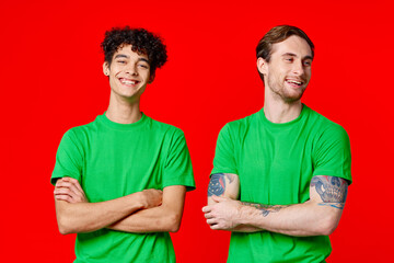 two friends green t-shirts fun red background communication