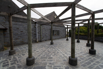 wooded pergola with slate floor tiles and slate roofing and walls