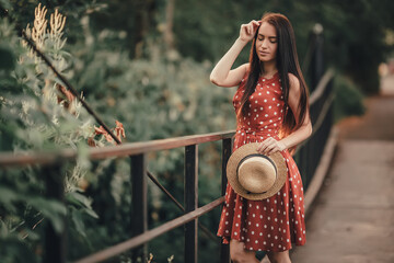 Young girl in retro dress posing in nature.