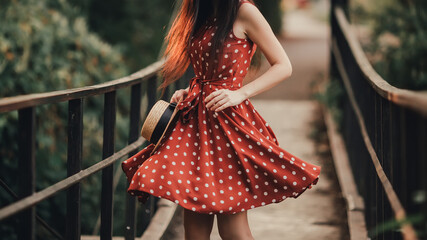 Young girl in retro dress posing in nature.