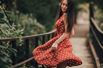 Young girl in retro dress posing in nature.
