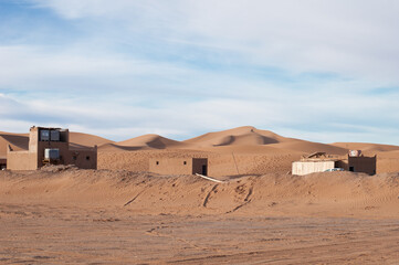 berber camp inendless expanses of the Sahara huge sand dunes at dawn of sunrise 