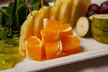 Set of sliced fruits on a plate.