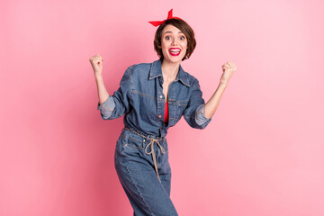 Portrait of attractive funky cheerful brown-haired girl celebrating best luck having fun isolated over pink pastel color background