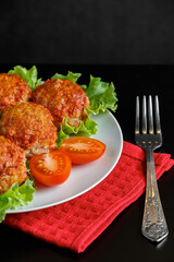 Appetizing meat balls in tomato sauce on a dark background. High protein dish.