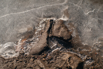 Textured rocks by the frozen river 