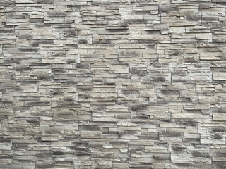 Brick wall in landscape position formed of thin grey bricks good to attach a chimney or electrical heater to it.