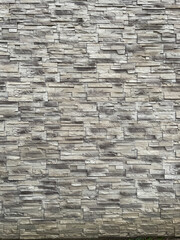 Brick wall in portrait  position formed of thin grey bricks good to attach a chimney or electrical heater to it.