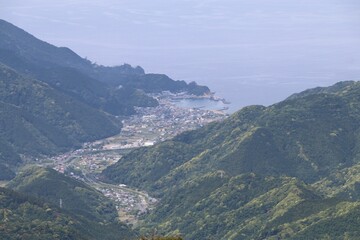 Fototapeta premium 伊豆山稜歩道の風景。伊豆の山々の尾根道を歩くコース。伊豆の高原、山々を眺めを楽しみながらのウオーキング。 海、そして海の町。仁科峠より。