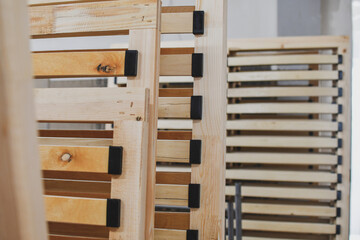 Stacked wooden slats for beds, production of furniture elements. - obrazy, fototapety, plakaty