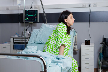 Hospitalized patient lying in bed during illness consultation waiting for physician doctor in...