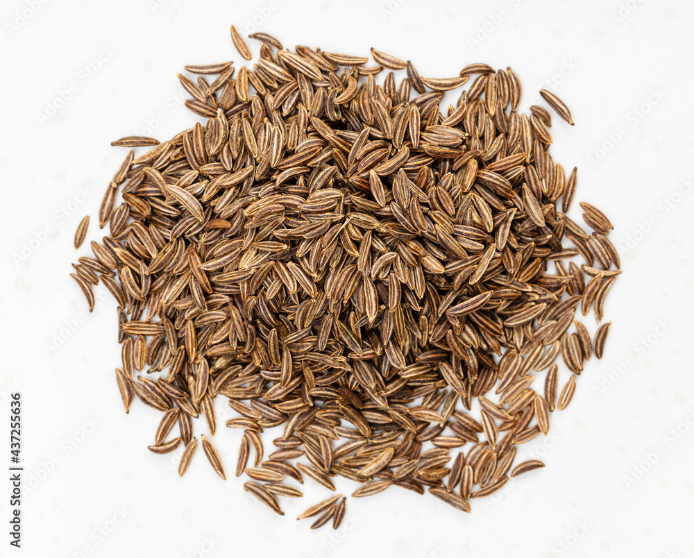 Wall mural top view of pile of caraway seeds close up on gray