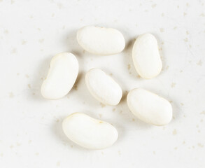 Fototapeta na wymiar several raw white beans close up on gray