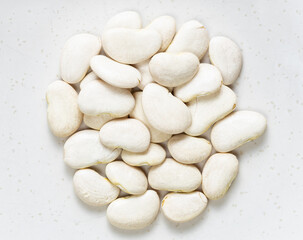 Fototapeta na wymiar pile of raw lima beans close up on gray
