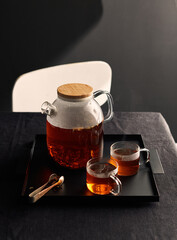 black Japanese tea on a tray on a dark background