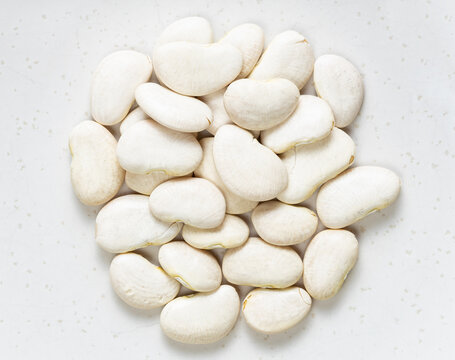 pile of raw lima beans close up on gray