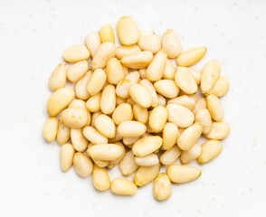 pile of shelled pine nuts close up on gray