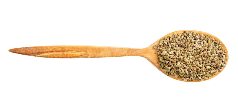 top view of wood spoon with ajwain seeds isolated