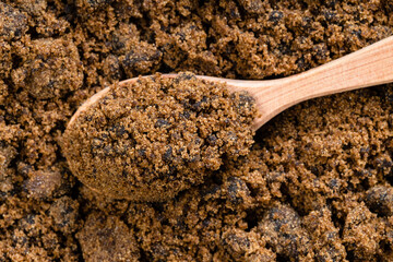 top view of spoon with dark muscovado cane sugar