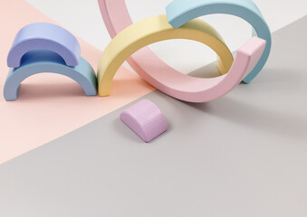 Geometric wooden shapes on pink gray background. Creative toys for kindergarten, preschool or daycare.
