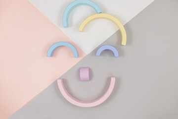 Funny face of smiling clown made with geometric shapes on pink background. Logic games, education, creativity tool for kids. Toys for kindergarten	