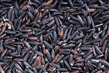 background - many raw black rice grains
