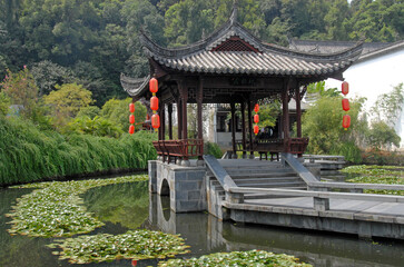Jiangwan in Wuyuan County, Jiangxi Province, China. Jiangwan is an ancient town in Wuyuan County known for its Tang Dynasty architecture. Pavilion with red lanterns in a lotus pond.