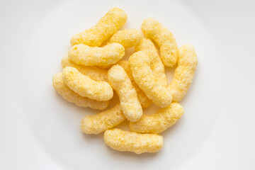 pile of corn puffs on white plate
