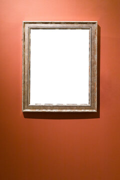 verical silver picture frame on red brown wall