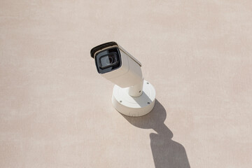 Cctv camera on wall of building in city. Security tracking concept close-up.