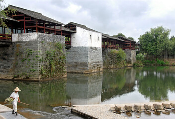 Qinghua in Wuyuan County, Jiangxi Province, China. The Qinghua Rainbow Bridge (Caihong Qiao) was a large stone beam bridge crossing the Le'an River. The Rainbow Bridge was destroyed by flood in 2020.