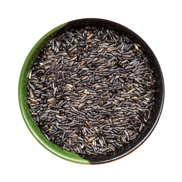 whole-grain niger seeds in round bowl isolated