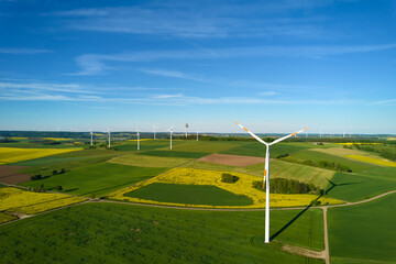 many wind turbine in the field, blue sky. aerial view
