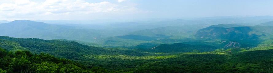 A view of the mountains covered with dense forest from the upper plateau of the Chatyr-Dag mountain range in Crimea. Panorama